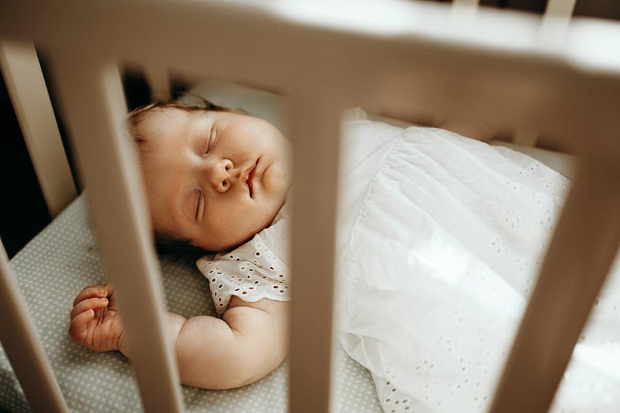 Bébé qui dort dans un lit à barreau